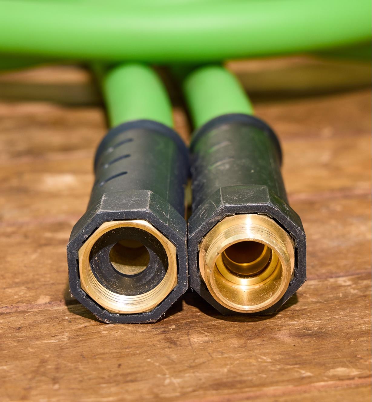 The ends of a 3/4" hose with plastic swivel collar and brass fittings