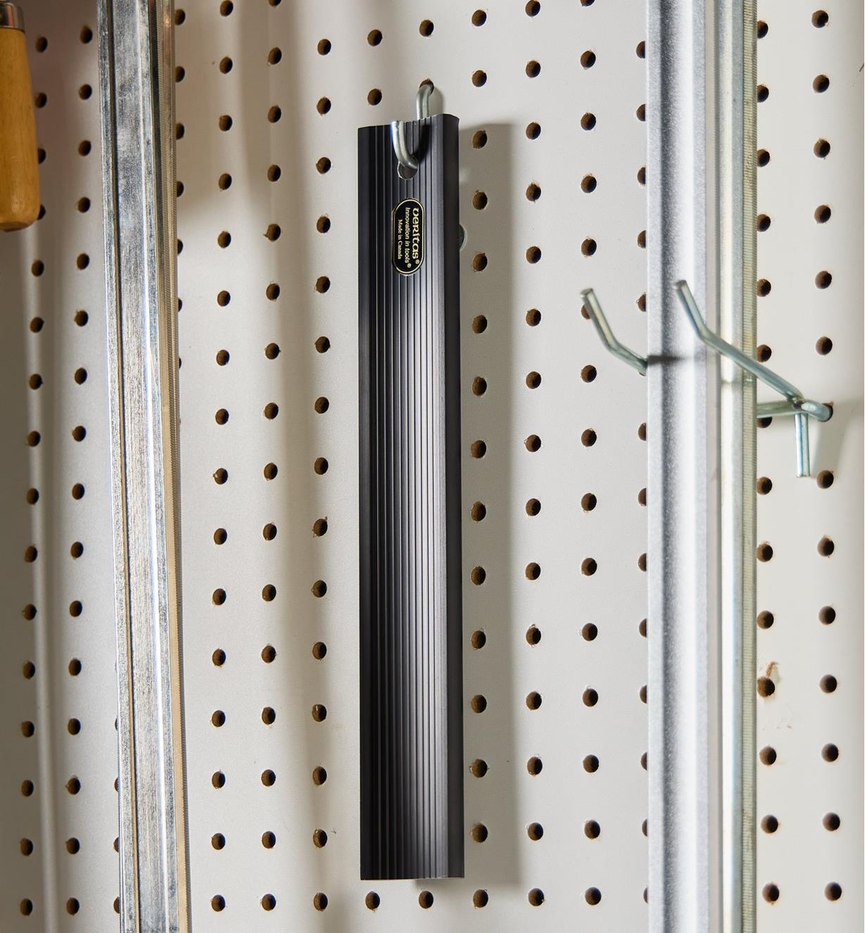Straightedge hanging on a pegboard hook