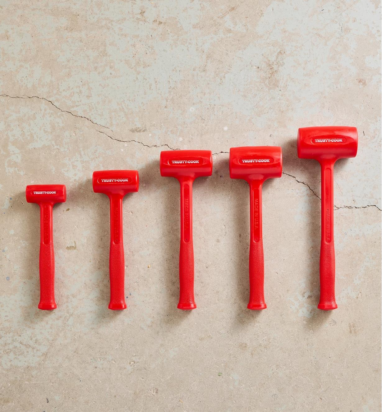 All sizes of dead-blow hammers lined up