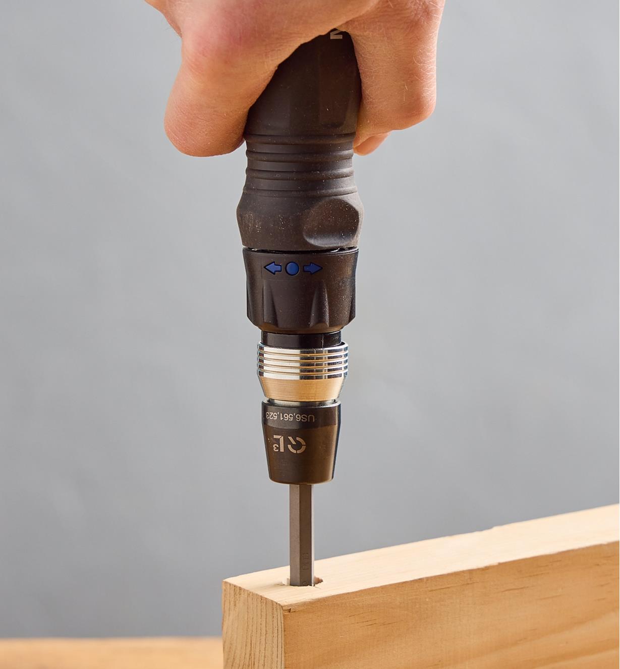 Using a 10-in-1 ratcheting screwdriver to access a recessed screw