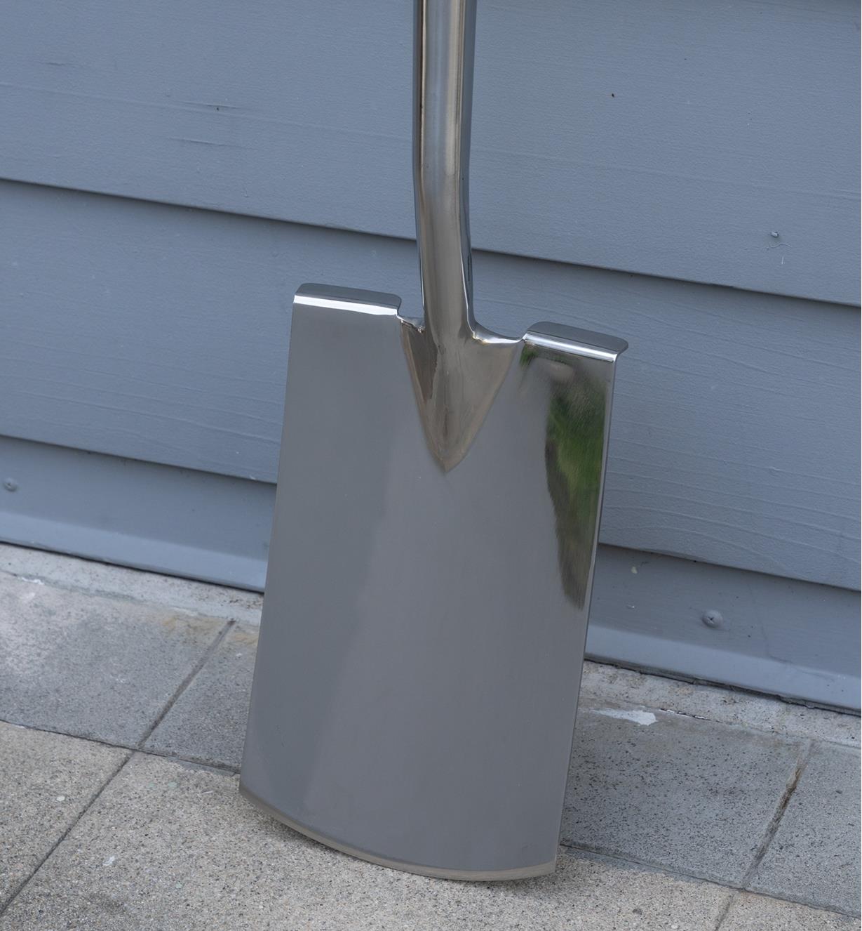 The stainless-steel head of the digging spade