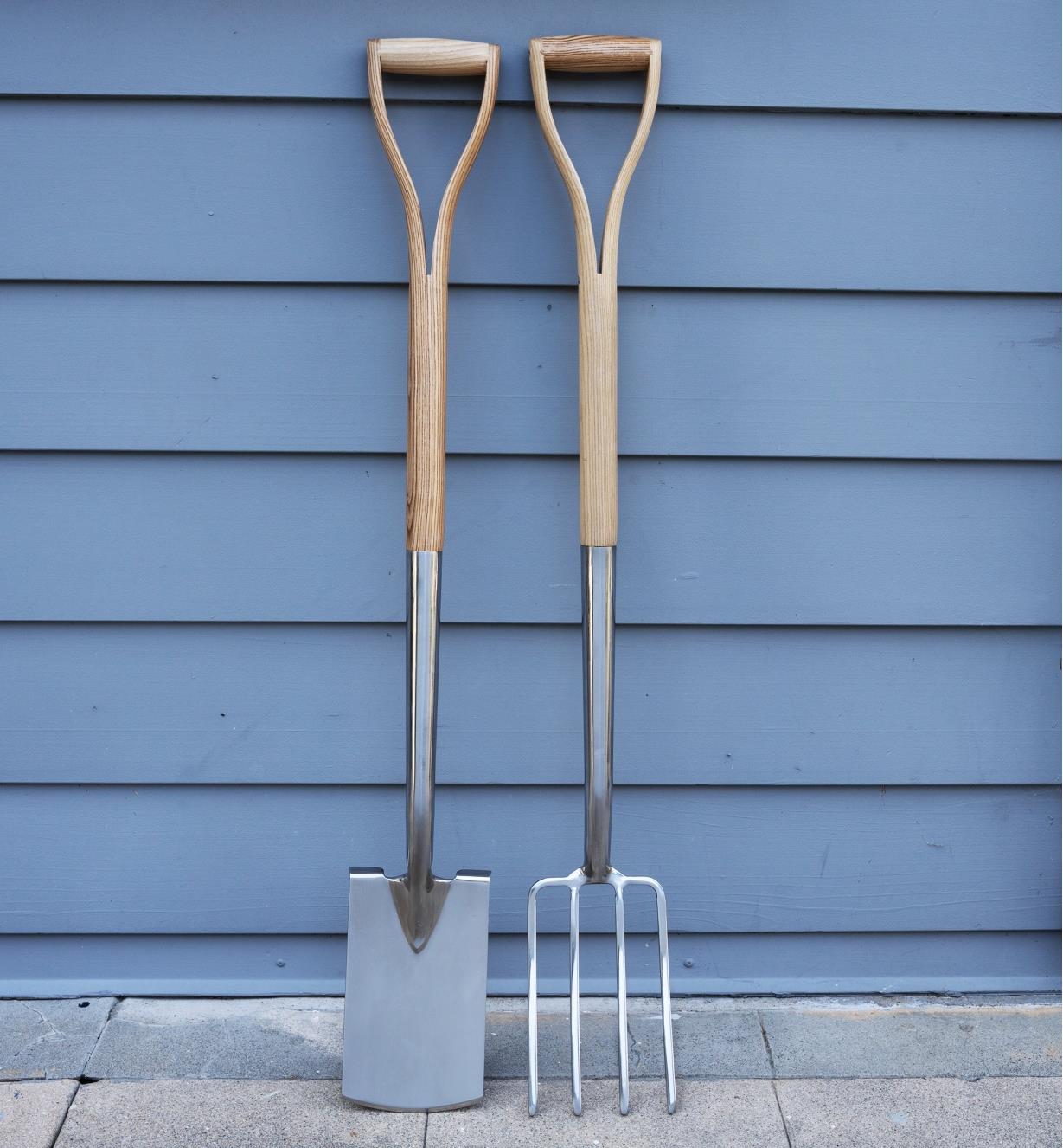 The border spade and border fork side by side leaning against a wall
