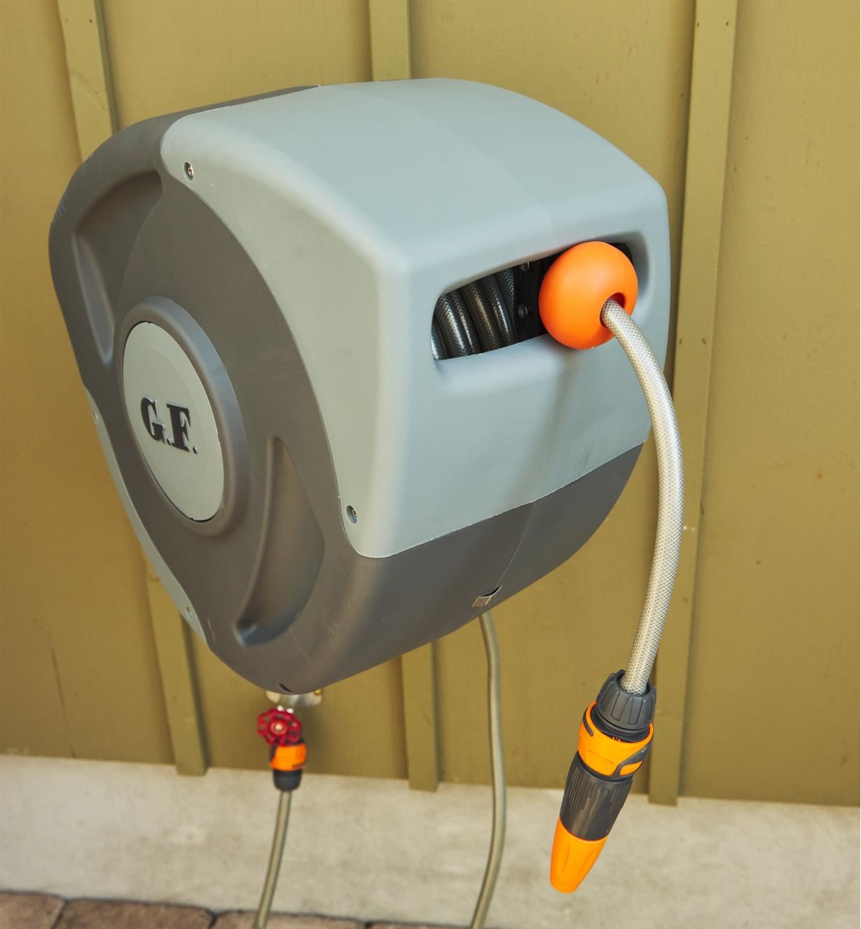 The auto-retracting hose reel is mounted to a wall.