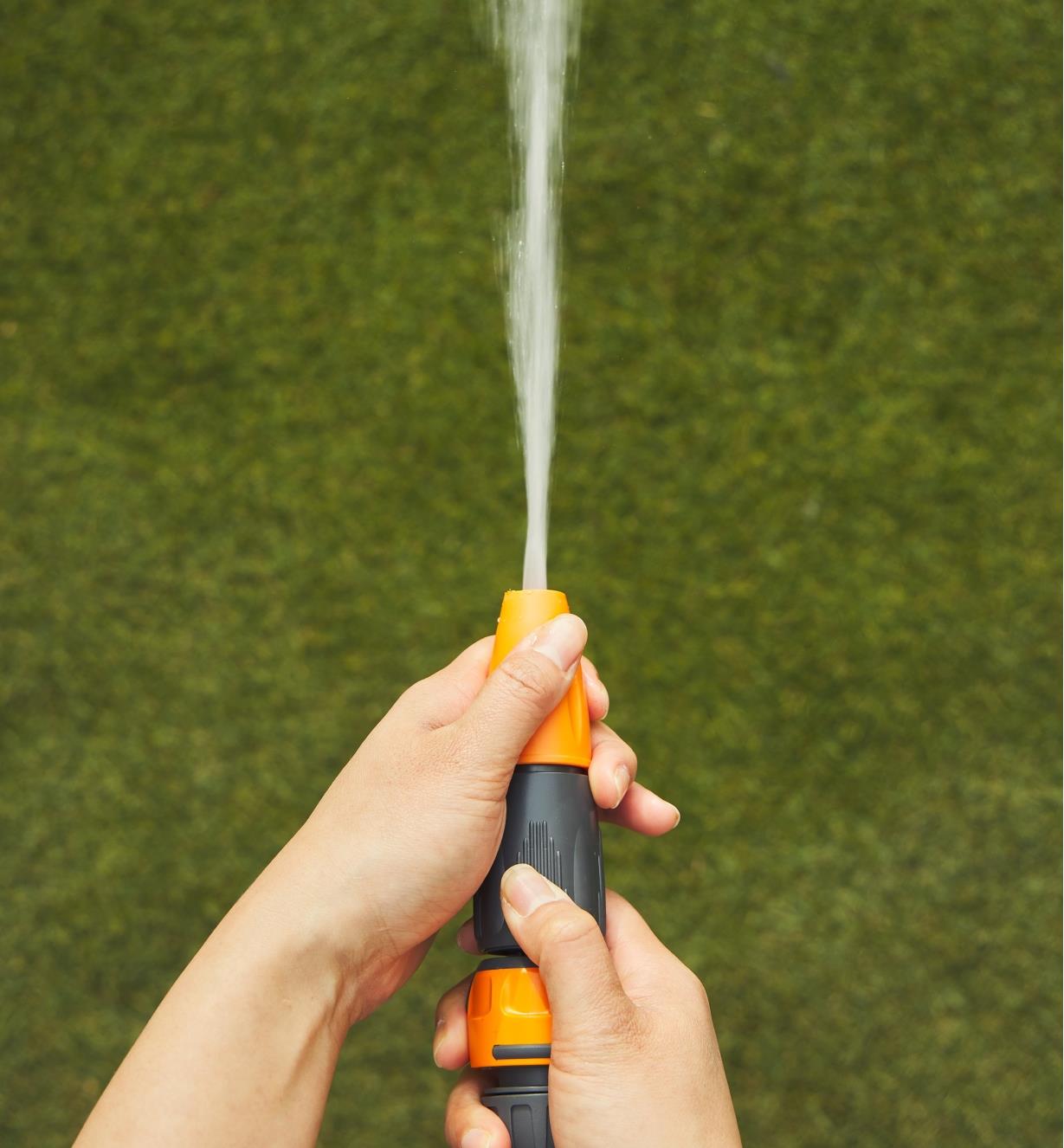 The spray gun on the hose sprays a jet stream of water