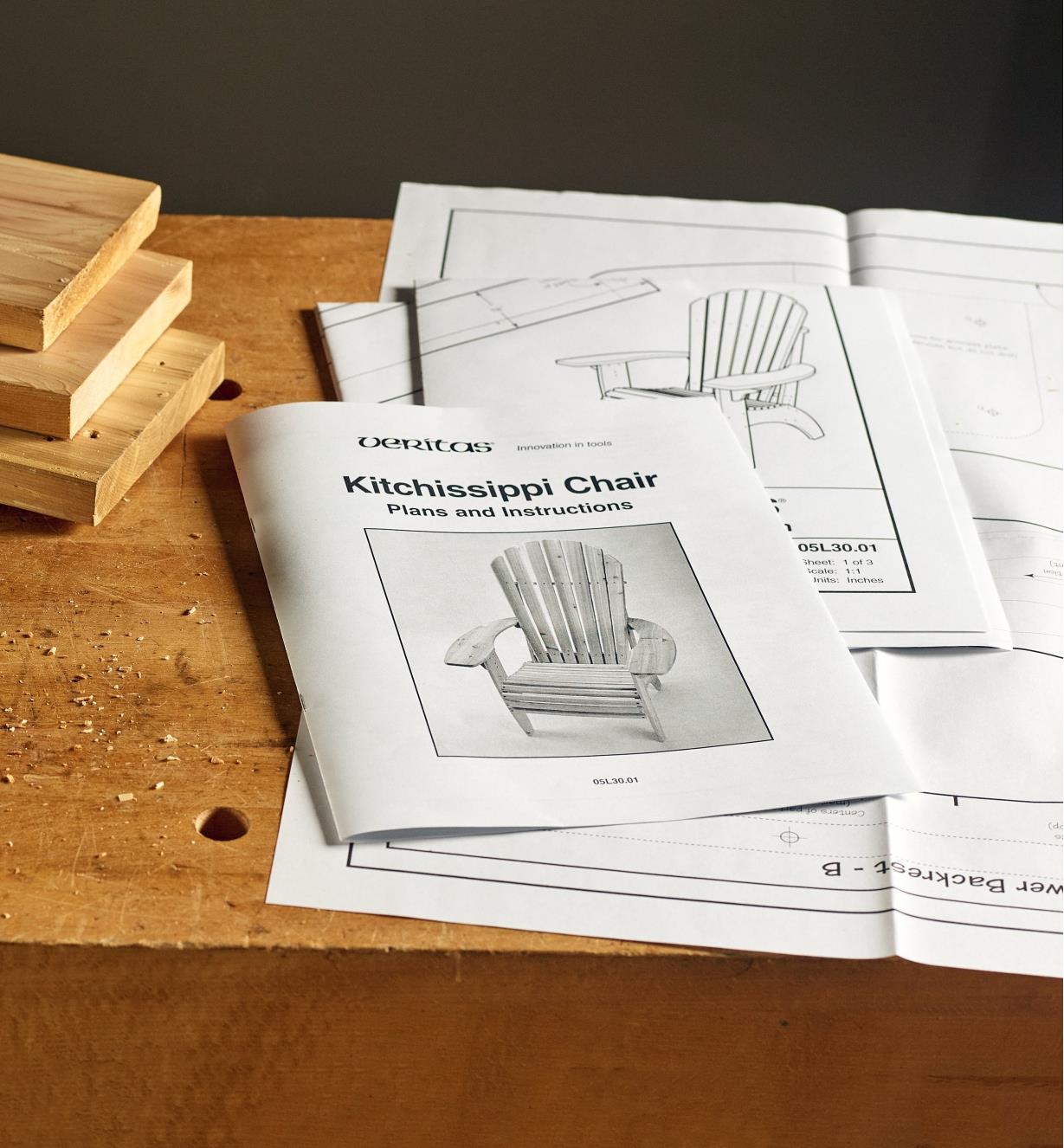 The Kitchissippi Chair Plan spread out on a workbench with wood pieces beside it