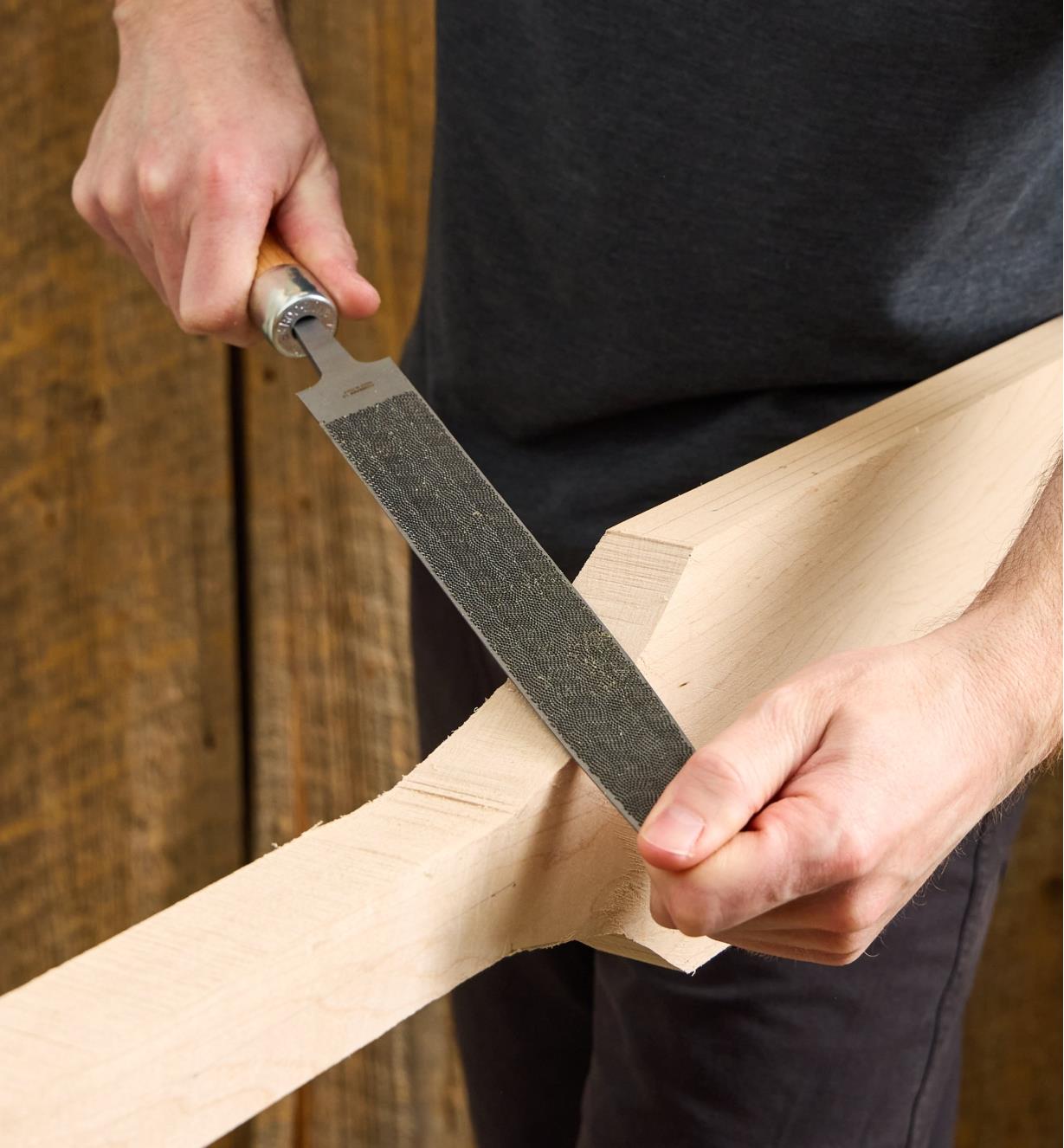 Using a Corradi half-round rasp to shape a wooden canoe paddle