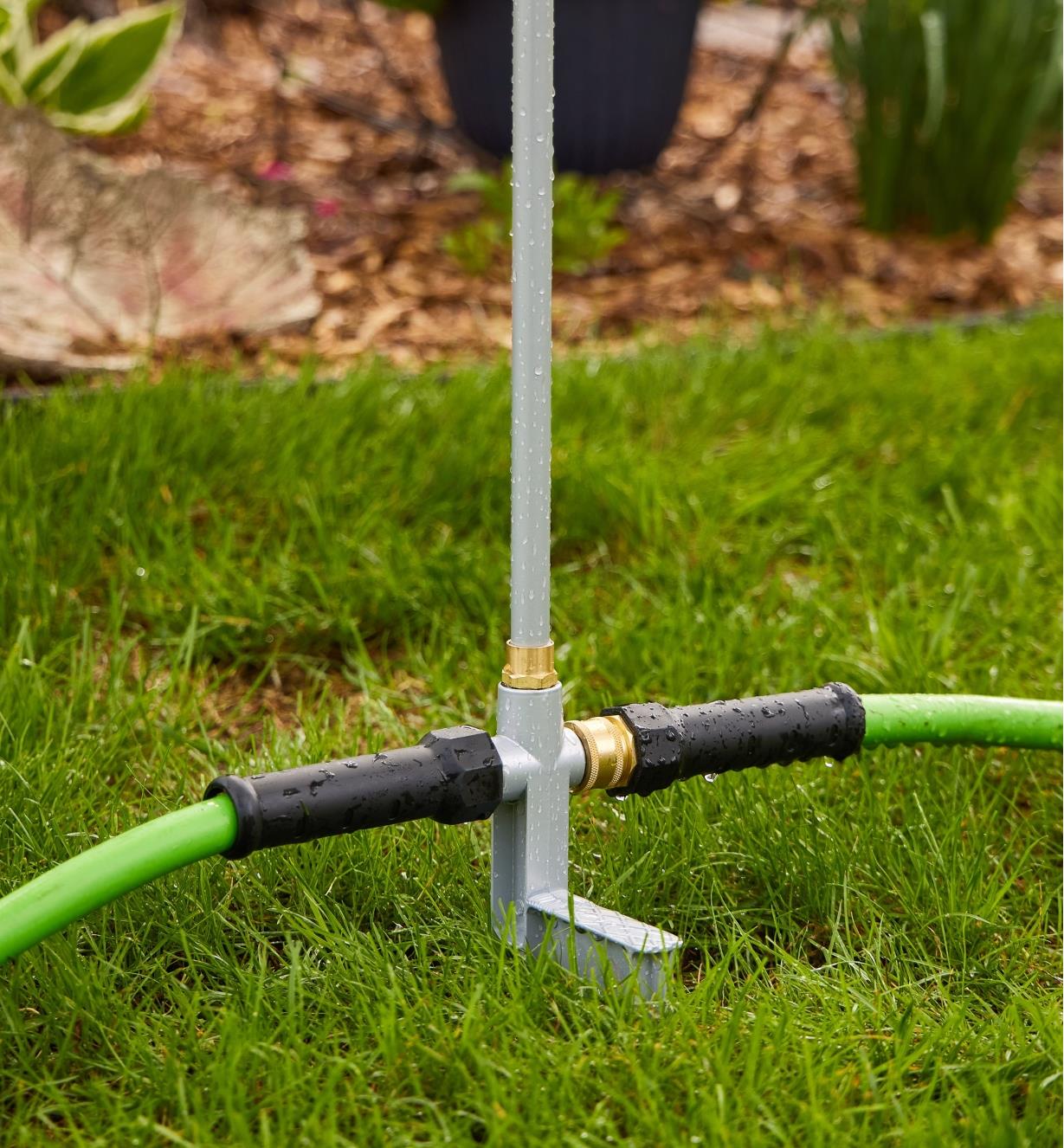 Two hoses attached to either side of the base of a telescoping sprinkler