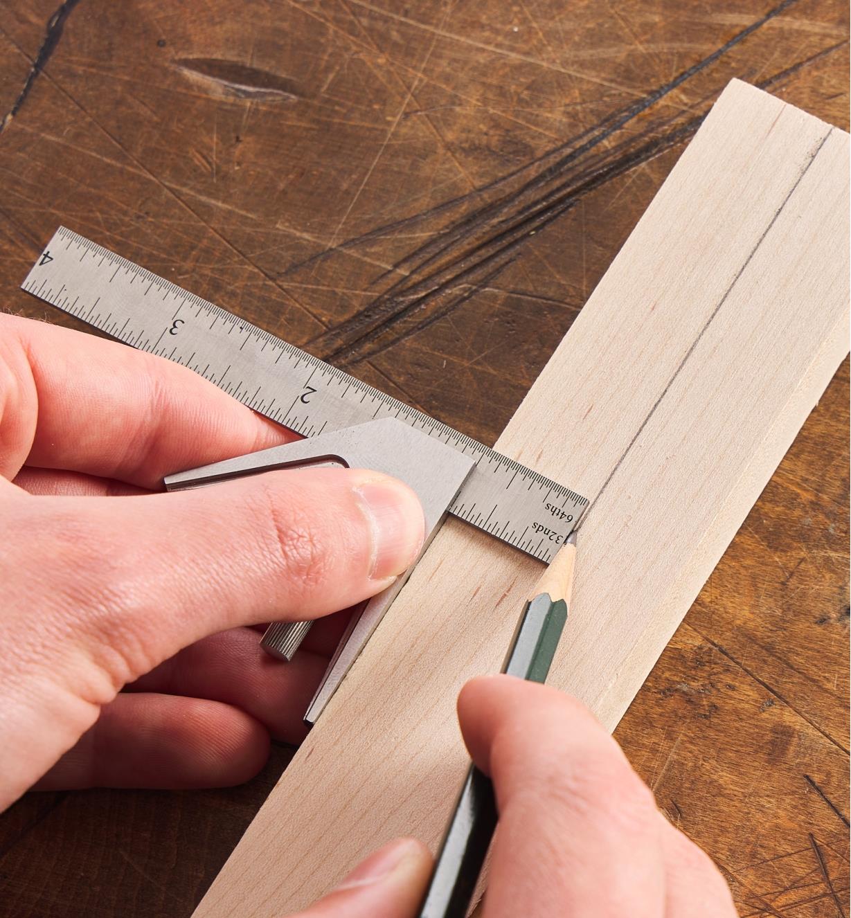 Using a pencil and a 4" combination square to mark a line at 90° to the edge of a wooden workpiece