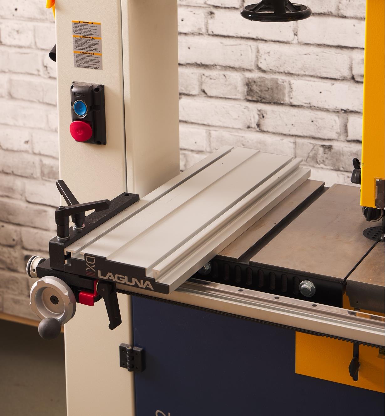 A Laguna DX3 Driftmaster bandsaw fence mounted on a bandsaw table in the horizontal orientation