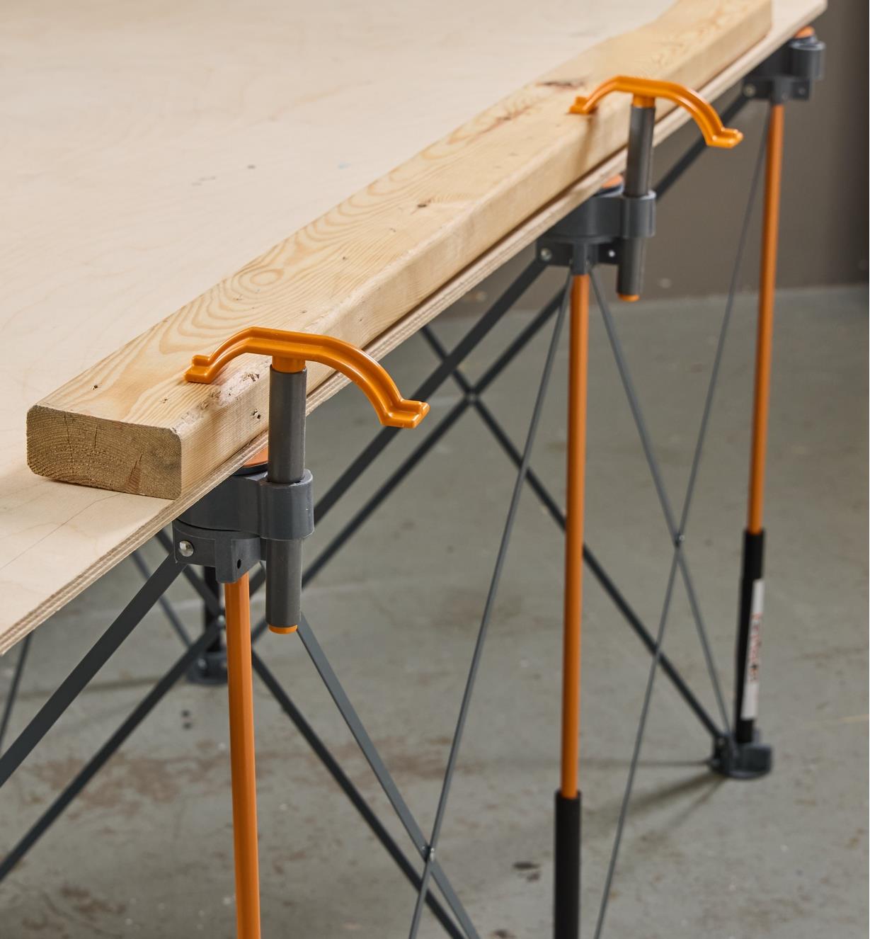 Lumber secured to the top of a Bora Centipede table with the included hold-down clamps