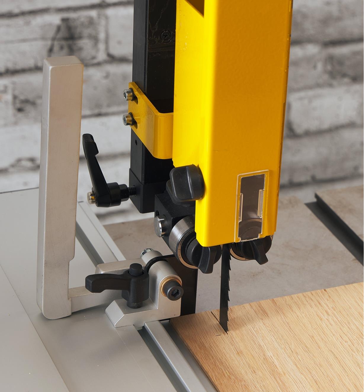 The flip stop mounted on a Laguna DX3 Driftmaster fence positioned horizontally on a bandsaw