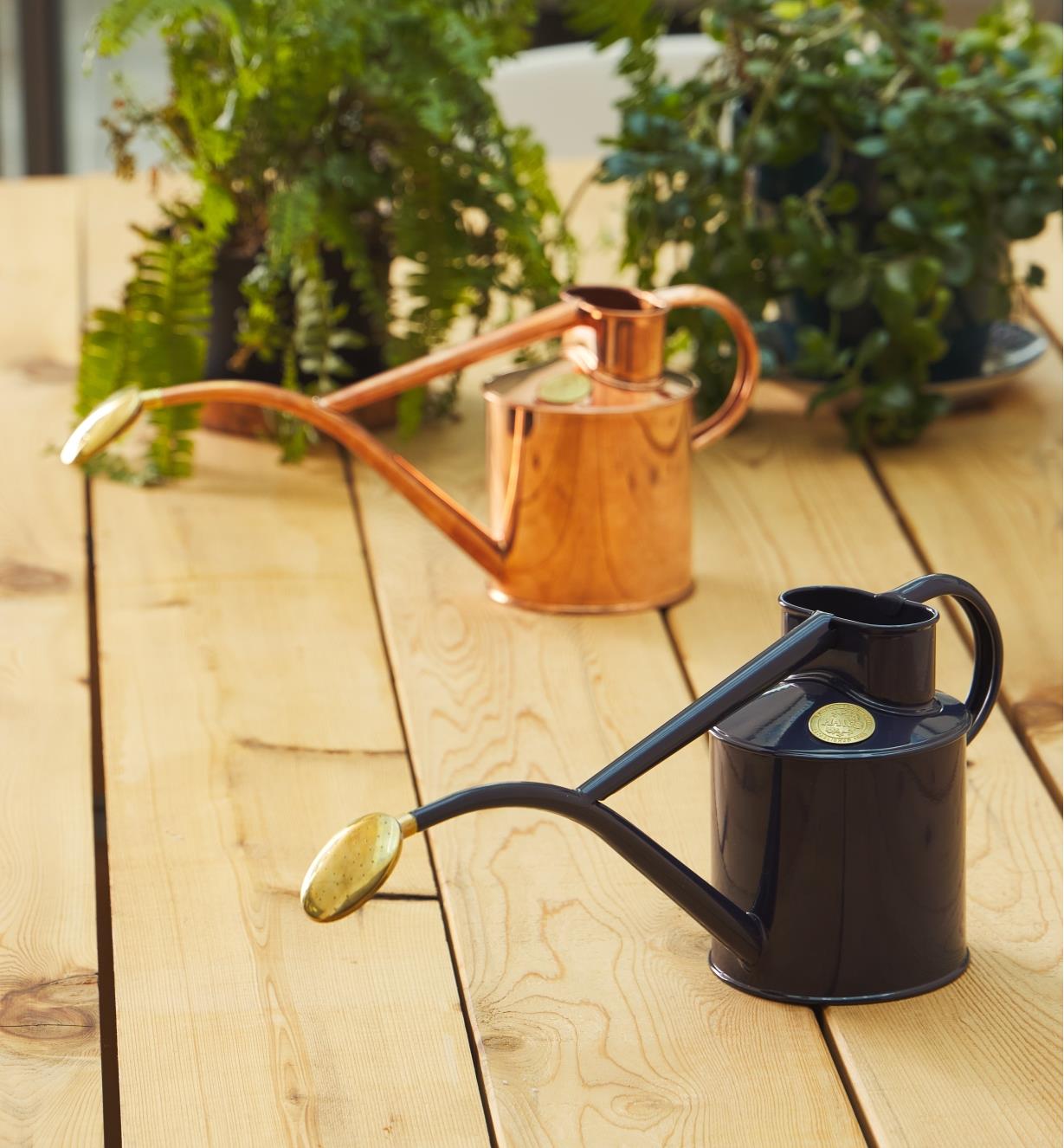 The Haws copper and British blue watering cans sitting side by side