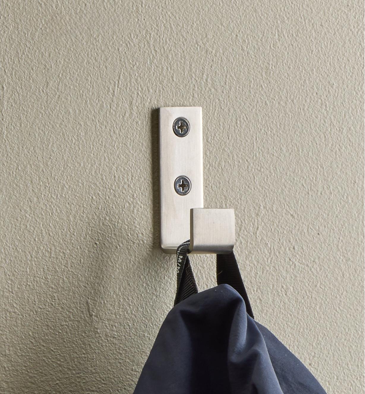 Clothing hanging from a stainless-steel single utility hook