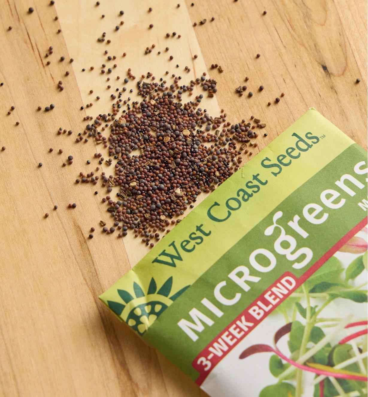 Three-week blend microgreen seeds scattered on a wood surface