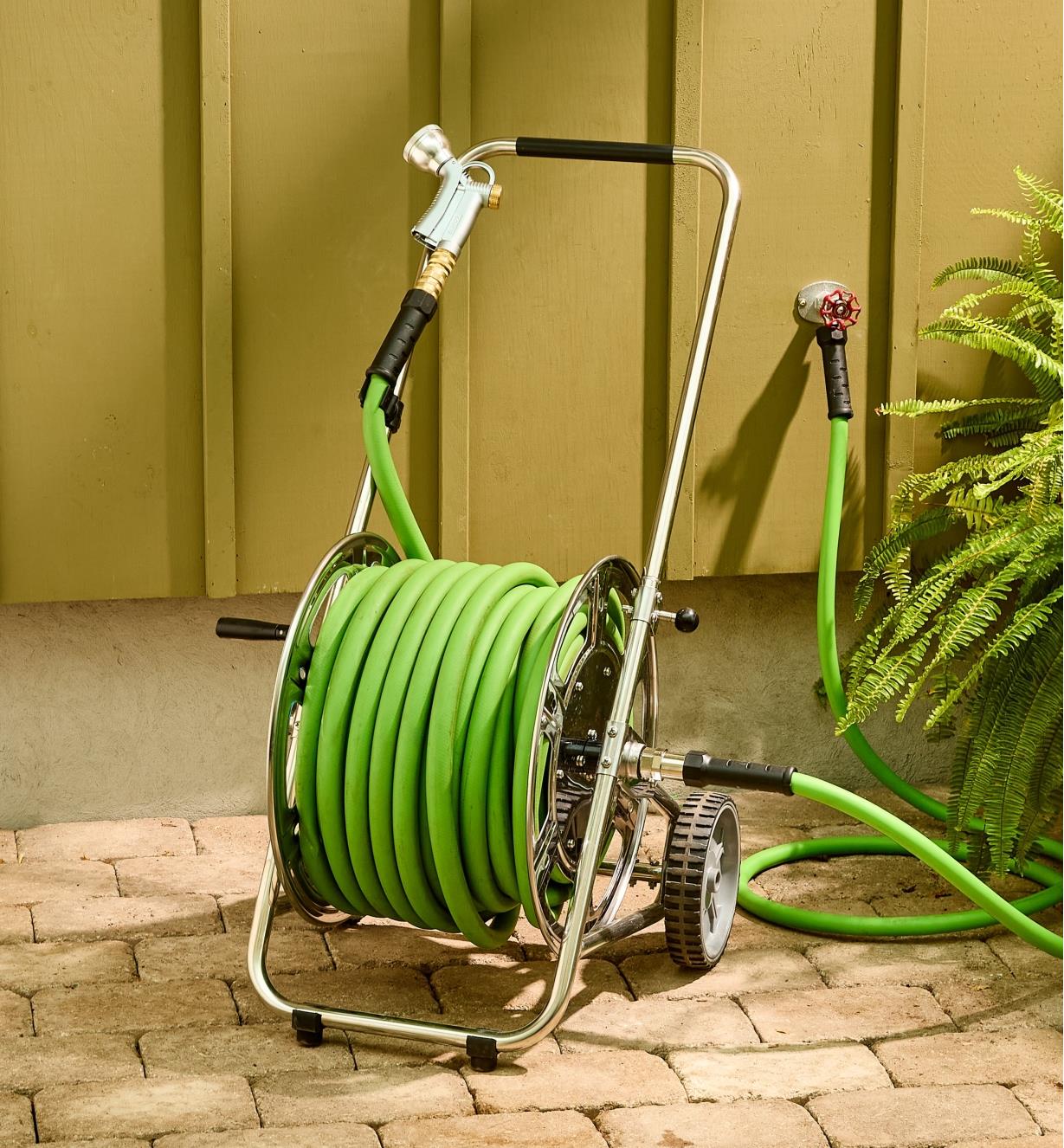 The stainless-steel hose reel cart with a hose wrapped around it